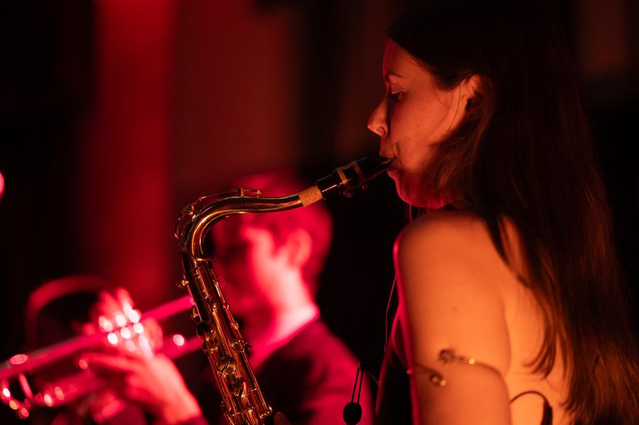 Saxophonist in red stage lighting