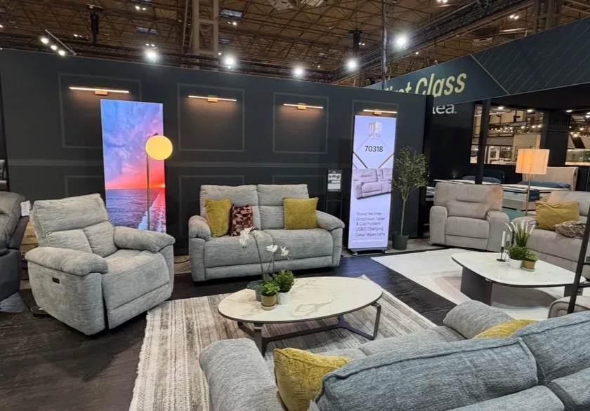 Interior display area with grey sofas and large LED wall panel