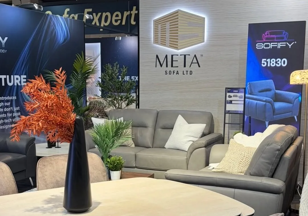 Meta Sofa Ltd illuminated brand sign above the stand with sofa displays below