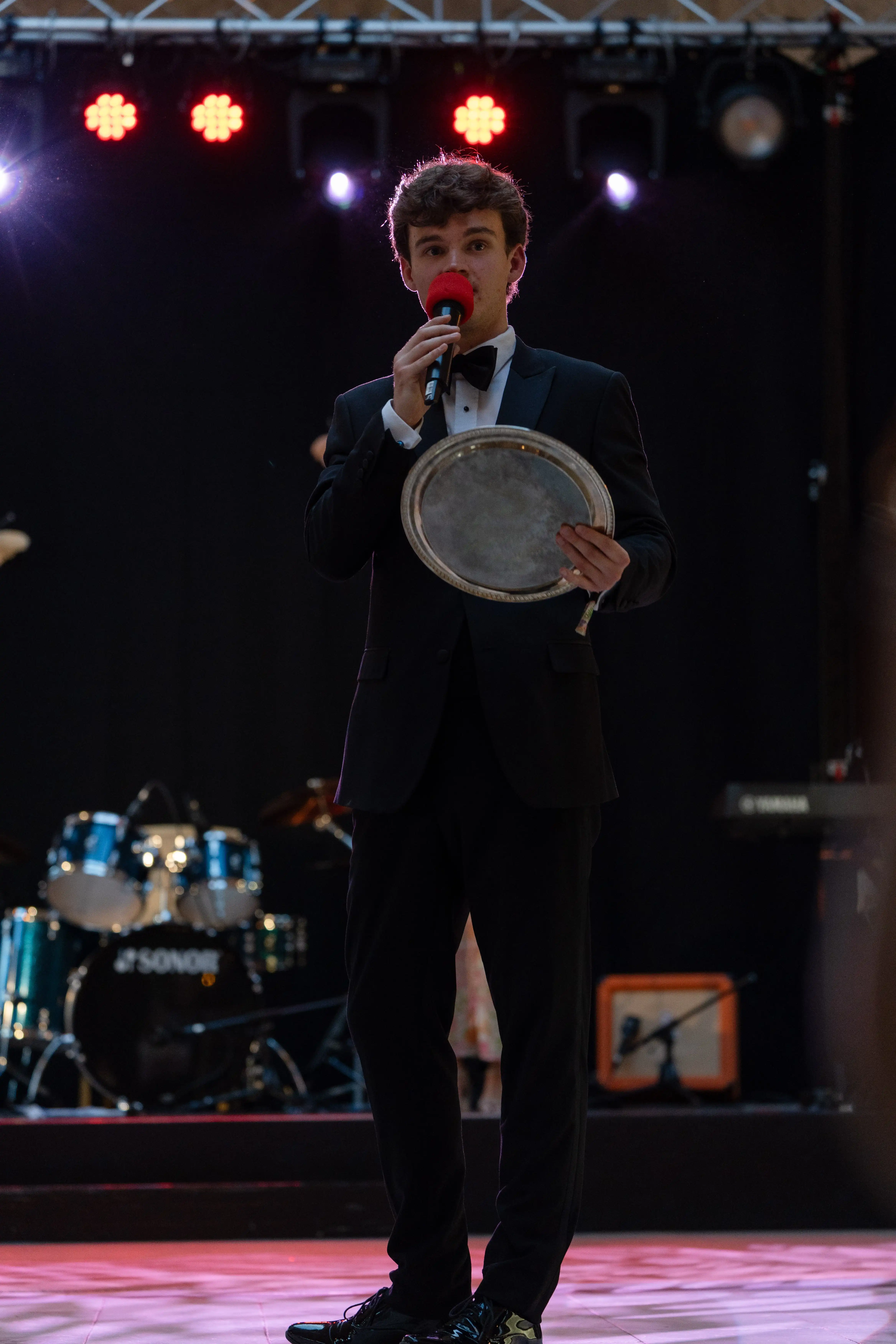 Host on stage with microphone during the evening's proceedings